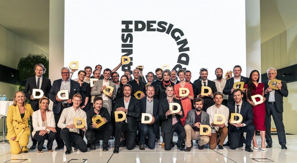 Danish Design Award winners with golden D prize cups.