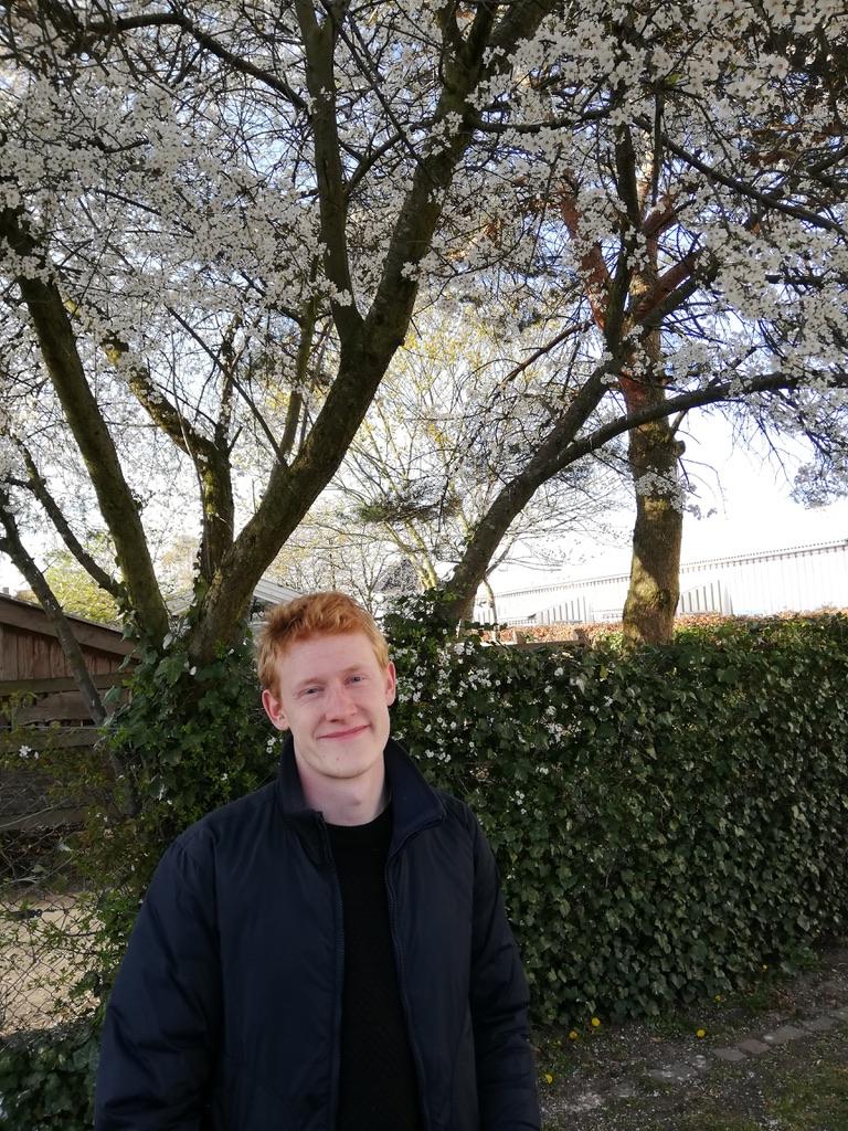 Picture of me in front of a blossoming tree.